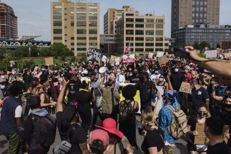 Crowd of Protesters Holding Signs